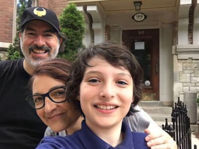 Finn Wolfhard is taking a selfie as Mary Joilvet and Eric Wolfhard are right behind him.